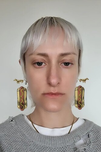 FIGURE 10. Digital Adornment filter ‘Hot Dog Earings’ (sic) by @wrld.space. The filter adds rotating hot dog earrings and smooths the skin; no other changes effect the image.