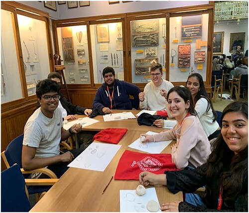 Figure 2. Dental students from King’s College Clinical Humanities & Wellbeing module closely observing and improving their haptic skills through drawing at the Gordon Museum, London. (Photo: Flora Smyth Zahra).