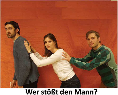 Figure 1. An example visual stimulus used in the German experiment, depicting an object-who question for the verb ‘push’. Visual credits: © Seckin Arslan, University of Potsdam.