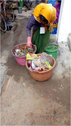 Figure 4. A woman worker segregating the waste outside a house. Photograph taken by the authors.