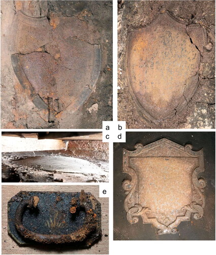 FIG. 8 Coffin plates from vault 2: (a,b) V2B and V2D stamped iron shields; (c) V2C brass shield, (d) V2E stamped iron pedimented shield with border (photos by J.R. Peterson).