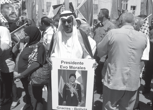 A Palestinian man in Ramallah holds a poster of Bolivian President Evo Morales during a 2014 rally in support of Latin American leaders. ZUMA PRESS, INC./ALAMY STOCK PHOTO