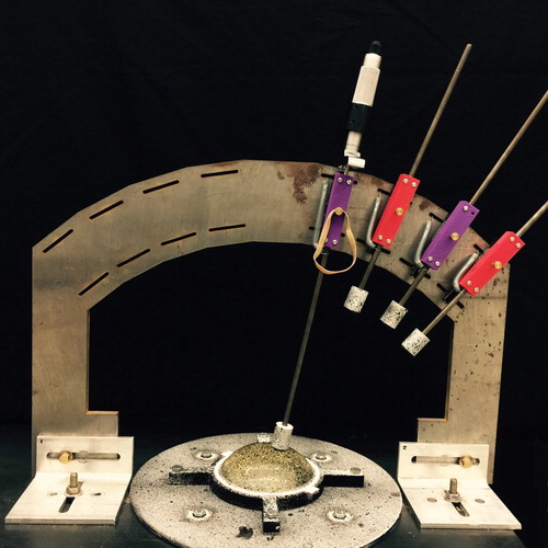Figure 8. ‘Arc’ system for applying consistent indentations (tissue phantom in tray sits on speckled rotatable disc. Linear slides guide rods with locating cylinders and indenter heads. A micrometer holds the rod in place. Rubber bands hold the locating cylinders away from the phantom during indentations).