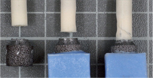 Figure 3. Representative examples of the failure modes of the porous metal-cement interface probes. On the left is an example of tensile failure. In the middle and on the right are examples of torsional failure.