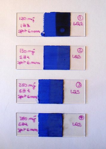 Figure 6. LQS laser, loosely-adhered dirt applied on the right side of the slides. Slide 1: the first spot obtained with Fl = 0.45 J/cm2, E = 130 mJ, spot = 6 mm, f = 5 Hz gave positive results. Slides 2,3,4: increasing fluence, energy, and did not give the same good results.