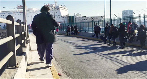 Figure 2. Walking alongside refugees: Ai (left) uses a cameraphone to film migrants boarding a ferry.