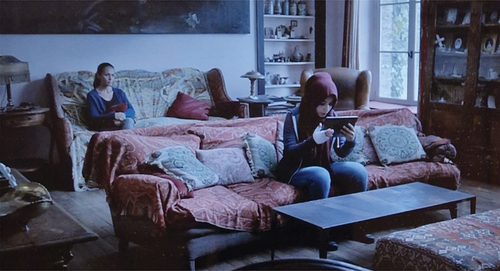 Figure 5. A medium shot foregrounds Chama video-calling Louis while Inès watches over her in the background. Screenshot from Durringer’s Ne m’abandonne pas (TV5 Monde, Citation2016).