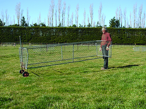 Figure 6  Ray Moss relocating a pipe framed pasture cage with the aid of ‘Charlie’.