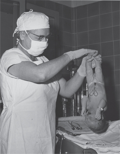 Figure 1 Dr Virginia Apgar holds a newborn baby upside-down to test its reflex irritability – one of the five Apgar score items (1959). Copyright © 2009. Reproduced with permission. Series 6 of the L. Stanley James Papers (MS 0782) in the Mount Holyoke College Archives and Special Collections. Available from: http://mtholyoke.cdmhost.com/u?/p1030coll8,3155.