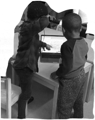 Figure 2. Students work with digital microscopes. Students could work individually or in small-groups at ateliers which supported science investigations with worms and opportunities to work with digital tools such as microscopes and laptops.