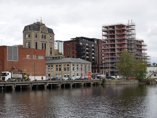 Figure 7. The eastern part of Klosterøya is facing the river and viewed as a potential for compact building. The photo shows how Spriten, a designated former industrial building and now cultural centre and art gallery, is becoming surrounded by new development (2021). Photo: O.H. Hagen.