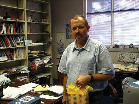Figure 3 Dmitry M. Rudkevich in his office (UT Arlington, 2006), surrounded by chemistry textbooks and new ideas. (Photo by Dr. Hexiang Zhang).