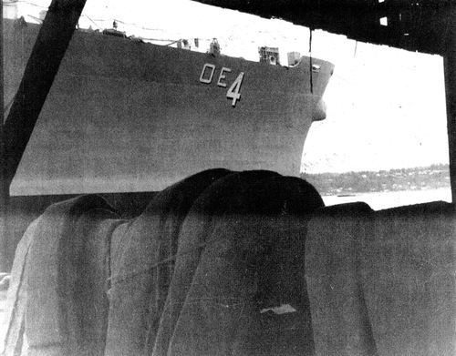 Figure 3.  The U.S.S. Detroit, a fast combat support ship, with asbestos cloth supplies stacked dockside. Photo source: Carl Mangold. Previously published in Hollins et al., Citation2009.