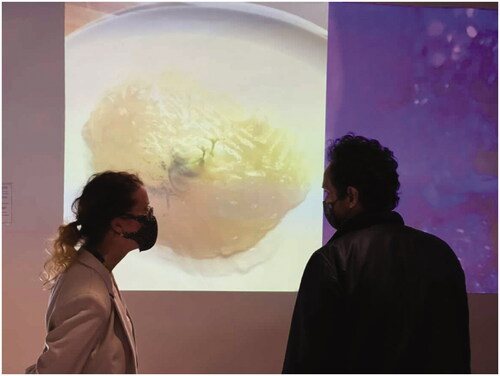 Figure 2. Photograph of Anna Roberts with Plastic Surgeon, Partha Vauide in front of ‘Blooming Tumour (2021) and Crystal Universe (2021)’ [photograph] Image Courtesy of Anna Roberts ©.