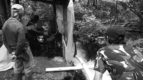 Figure 2 Local farmers studying hydroelectric technology (photo by the authors).