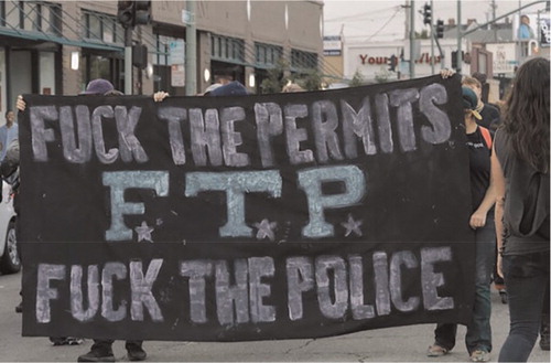 Protest sign at roving party/protest, Oakland, August 2012 (p. 727).