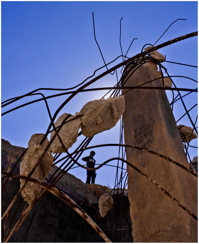 Figure 3. A Palestinian Bedouin standing on the edge of a destroyed well built by the villagers of Umm Al Kheer.