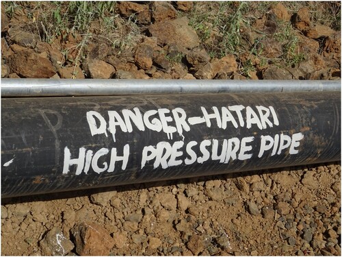 Figure 4. 11-inch main pipeline and 5-inch community pipeline with warnings in English and Kiswahili. Photo courtesy David Greven.