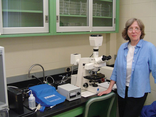 Figure 1. Martha J. Powell beside her trusty microscope in her laboratory.