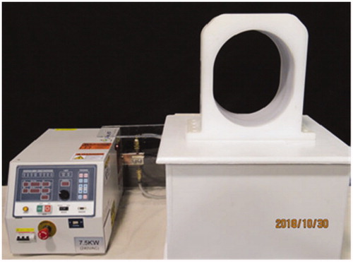Figure 2. Photograph of laboratory induction heating system used for initial characterization of heating from MNP-filled balloon implants, including radiofrequency power amplifier, matching network and water-cooled 26 × 31 × 20 cm3 head coil (AMF Life Systems, Auburn Hills MI).