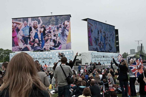 Figure 2. In Hyde Park, participants cheer as they see themselves on the big screen.
