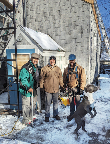 Figure 4. Brothers Charles “Kit” Eccles and Edward “Ned” Eccles, members of the church vestry; Tiago “Dell” Silva, a contractor; and a pit bull, “Monk,” on the construction site in January 2019. Photograph by Gabriel Cira.