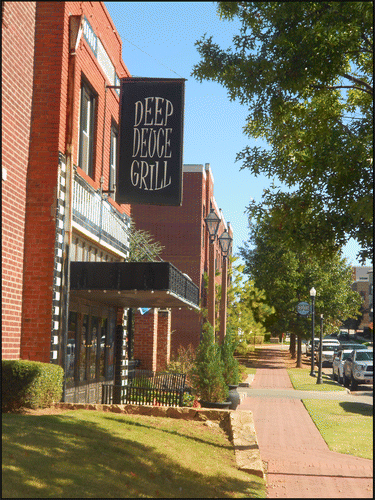 Figure 3. The first new‐build construction in Deep Deuce consisted of brick veneer low‐rise apartments designed to complement existing structures such as the historic property with the sign and metal awning on the far left. Photo by Alyson L. Greiner, 2017.