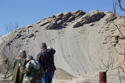 Toxic Tour visitors gazing at the enormous scale of an eroded chat pile. Credit: Clifton Adcock.