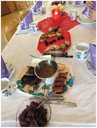 Photo 3. Photo from a Christmas meal showing food such as potatoes, red cabbage, sausages, gravy, and meatballs. One of the plates has two notes stating ‘halal’.