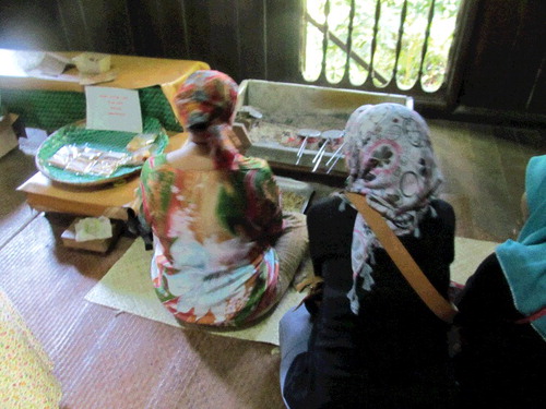 Figure 1. Tourists observing a demonstrator making kuehs. Source: author.