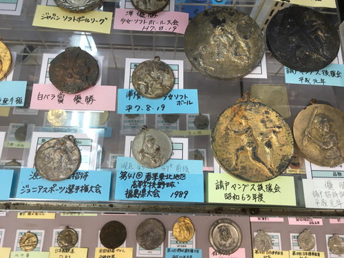 Figure 3. Medals in “Gift Shop” that were found in Fukushima in the wake of the disaster. Photo credit: Christopher Gaffney.
