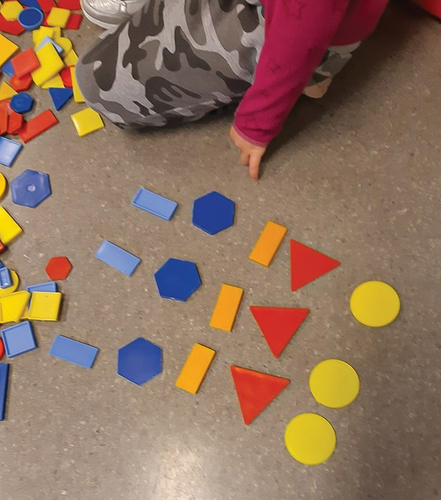 Figure 2. The girl’s repeating pattern made by plastic shapes. (Photo: Gladys Berntsen).