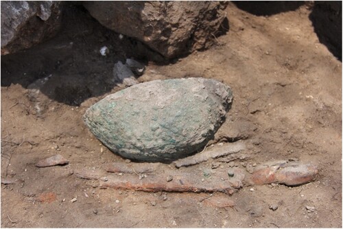 Figure 17 The cache from Locus 12/Q/76, which contained iron blades placed beside two stacked bronze bowls filled with additional items (courtesy of the Tel Aviv University Institute of Archaeology).
