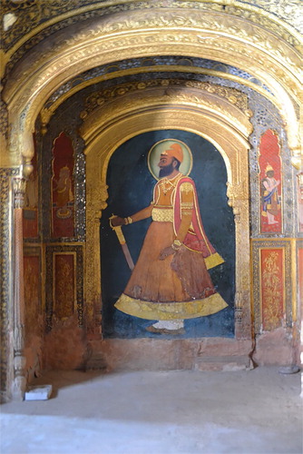Figure 2. Paintings of maharaja Karam Singh and various Vaishnava icons on the sides in the Audience Hall of Qila Mubarak, Patiala. Source: Author’s own photograph, 6 March 2014.