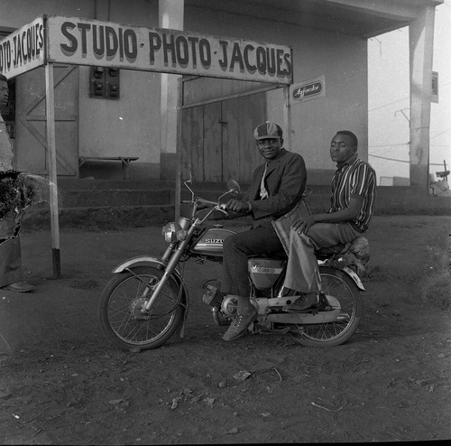 IMAGE 7. Clients posing with motorcycle outside the Photo Jacques studio. EAP054/1/125/181_dvd174_067. Reproduced courtesy of Jacques Toussele.