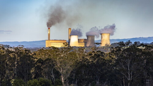 Pollution as an externality: Coal-fired power station emitting smoke from twin smokestacks and heat from three cooling towers—Yallourn Power Station in Latrobe Valley, Victoria.