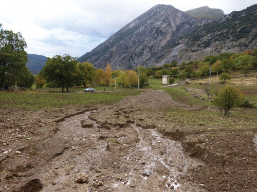 Figure 9. Soil erosion (mud flow) after heavy rainfall in the Maddalena catchment in November 2013. Site RB073 is located downslope of the rectangular transformer building in the middle distance. (Photo W. de Neef).