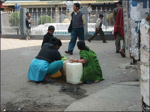 Figure 6. Collecting water from a hydrant in the main square of Darjeeling town.