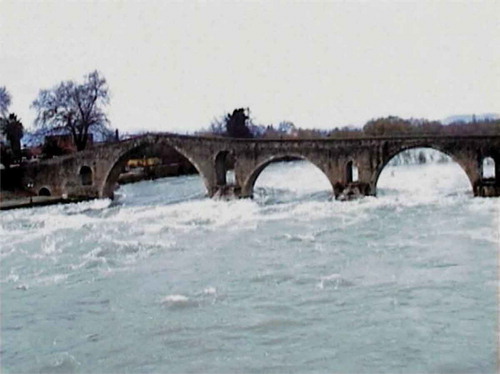 Fig. 6 Flood in the Arachthos River, Epirus, Greece, under the medieval Bridge of Arta, in December 2005. The bridge is famous from the legend of its building, transcribed in a magnificent poem (by an anonymous poet) symbolizing the dedication of the engineering profession and the implied sacrifice; see en.wikisource.org/wiki/Bridge_of_Arta.