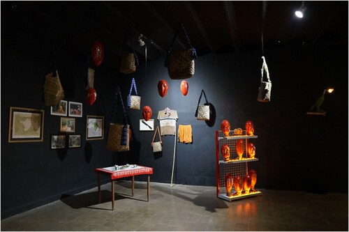Figure 3. Constantinus Ruharusun, Homour, 2021. Mixed media and found object installation, dimensions variable. The installation includes personal items and photographs from communities living in and around Pala plantations in Fakfak, as well as sculptures juxtaposing representations of the red pits of the pala fruit with figurative elements and fibre art motifs.