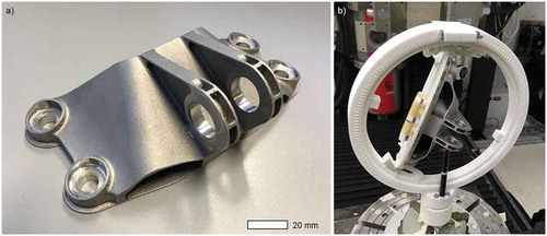 Figure 2. (a) Engine bracket from AlSi10 Mg generated by SLM and (b) additively manufactured polymer (PA12) sample holder to fixate the sample´s placement during the XCT scan.