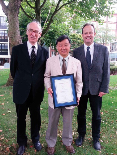 Figure 1. Geoffrey Luckhurst (left) presenting Hideo Takezoe (centre) with the 2014 Luckhurst–Samulski Prize, and the Editor, Corrie Imrie (right).