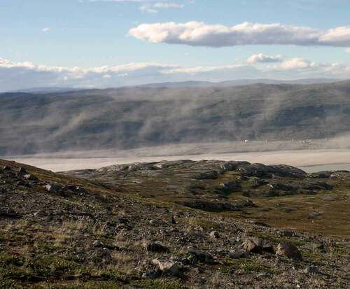 Figure 2. Dust entrainment from sediments at the head of the fjord near Kangerlussuaq, west Greenland, July 1, 2014. Photograph courtesy of Tom Matthews