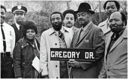 Figure 2. Kinloch residents pose with comedian and activist Dick Gregory, an alumni of Kinloch’s Dunbar School, on his visit back to the town in the early 1980s when they honored him with a street in his name. Image from Missouri State Historical Society, African American Experience in St. Louis Photo Archive, ca 1980.