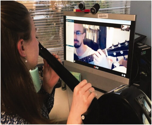 Figure 4. Individual music therapy telehealth session illustrating active music making on guitar.
