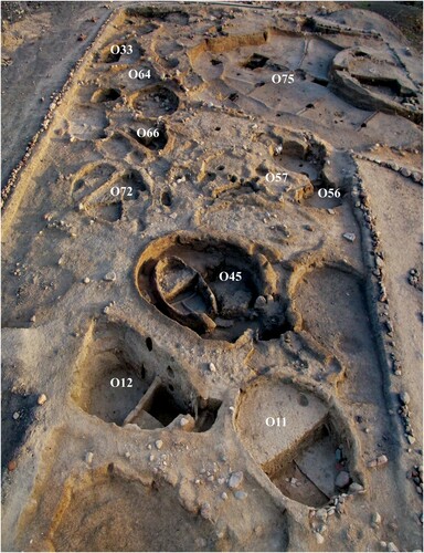 Figure 2 W16 showing cluster of semi-subterranean structures undergoing excavation in April 2010, labelling those referred to in the text (photo: S. Mithen and B. Finlayson).