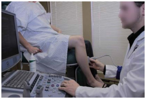 Figure 17 Scanning the lower extremity with patient seated on the exam table.