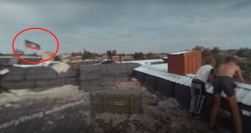 Figure 4. The Displaced (NYT). Oleg and his friend on the rooftop. Donetsk People Republic’s flag is seen on the background.