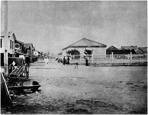 Figure 7. Tamoto Kenzō, ‘Kaitaku tōji no Hakodateshi shigai fũkei’ (Hakodate’s urban landscape at the time of colonial development), late nineteenth century albumen print. Reproduced as a photomechanical print. In Nihon shashinshi 1840–1945 (A history of Japanese photography 1840–1945) (Tokyo: Heibonsha, 1971), 31. Although captioned in this publication as an anonymous photograph, the curators of A Century of Japanese Photography discuss this image as certainly by Tamoto Kenzō, demonstrating his desire to capture a street scene while retaining the blur of pedestrians. Albumen print 19 × 24.4 cm. With permission of the Japan Professional Photographers Society.