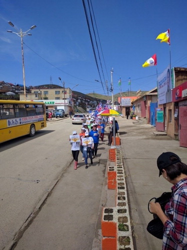 Figure 2. The bus stop in the north of the city in June 2016. Here, people are campaigning for a political candidate during the lead-up to Mongolia’s national parliamentary elections on 29th June. Photo R. Plueckhahn.